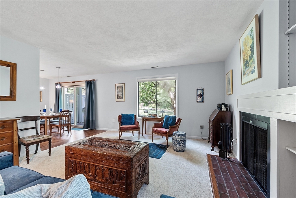 1 Concord Greene, Unit 7 Concord, MA 01742 - Photo 7 of 31 a living room with furniture a window and a fireplace