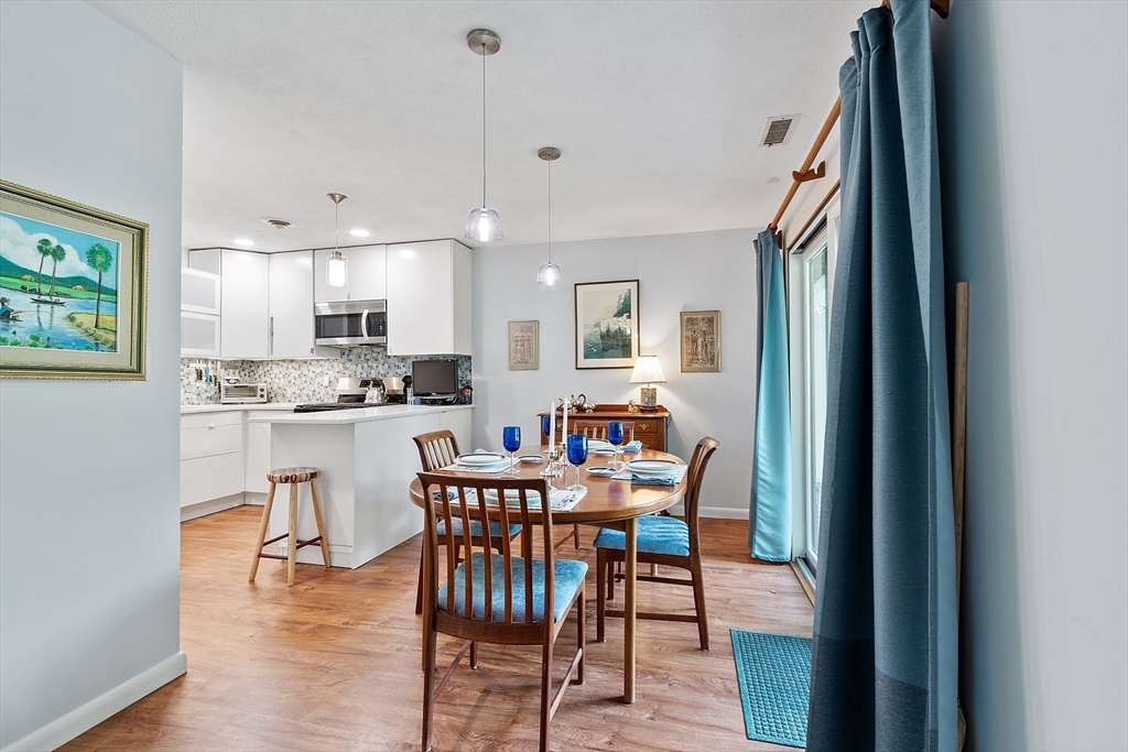 1 Concord Greene, Unit 7 Concord, MA 01742 - Photo 8 of 31 a view of a dining room with furniture and wooden floor