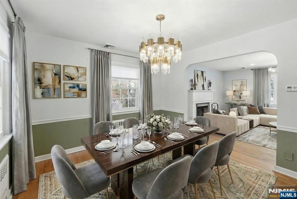 922 Wildwood Road Oradell, NJ 07649 - Photo 12 of 42 a view of a dining room with furniture a chandelier and wooden floor