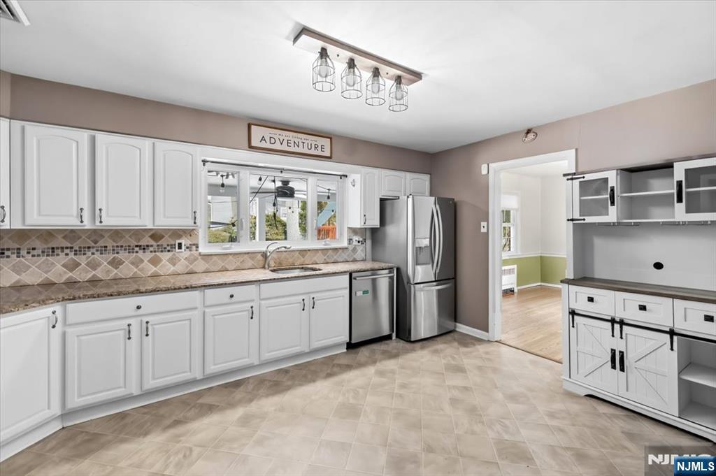 922 Wildwood Road Oradell, NJ 07649 - Photo 14 of 42 a large kitchen with stainless steel appliances granite countertop a stove refrigerator and cabinets