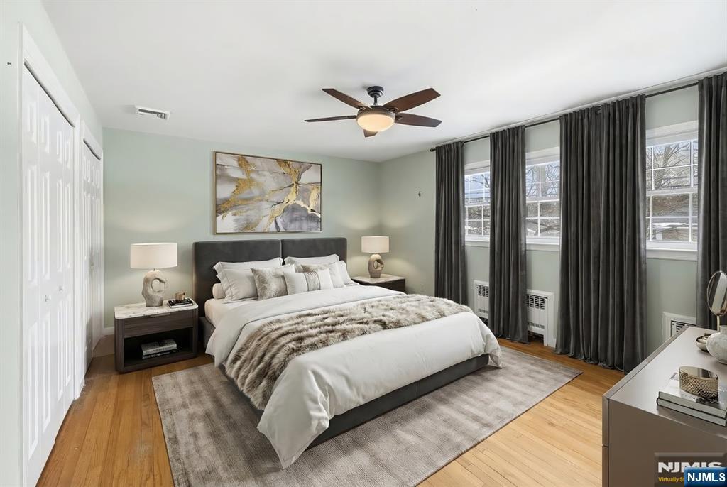 922 Wildwood Road Oradell, NJ 07649 - Photo 17 of 42 a bedroom with a large bed and a chandelier