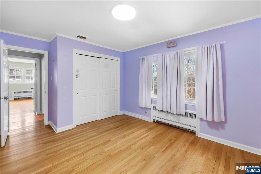 922 Wildwood Road Oradell, NJ 07649 - Photo 22 of 42 an empty room with wooden floor and windows