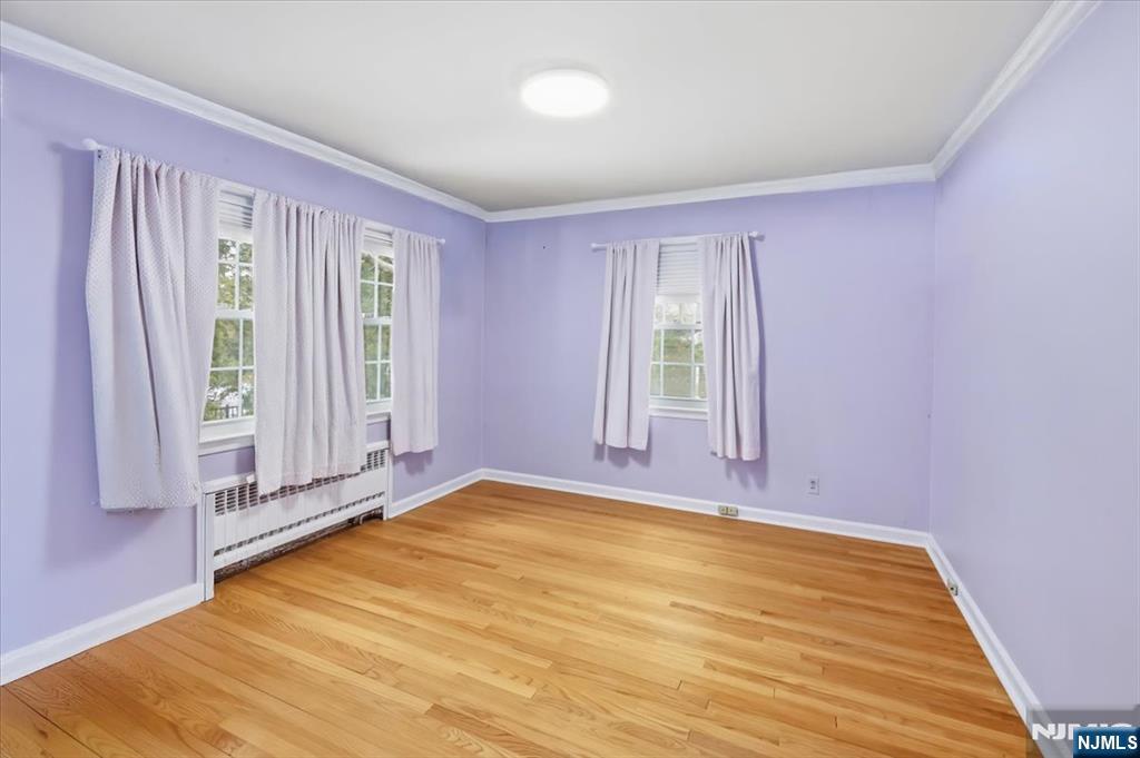 922 Wildwood Road Oradell, NJ 07649 - Photo 23 of 42 an empty room with wooden floor and windows
