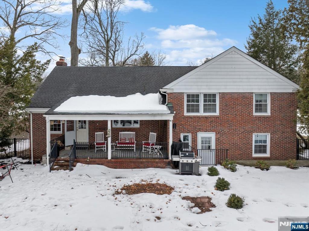 922 Wildwood Road Oradell, NJ 07649 - Photo 34 of 42 a view of a house with a patio covered with snow in the backyard