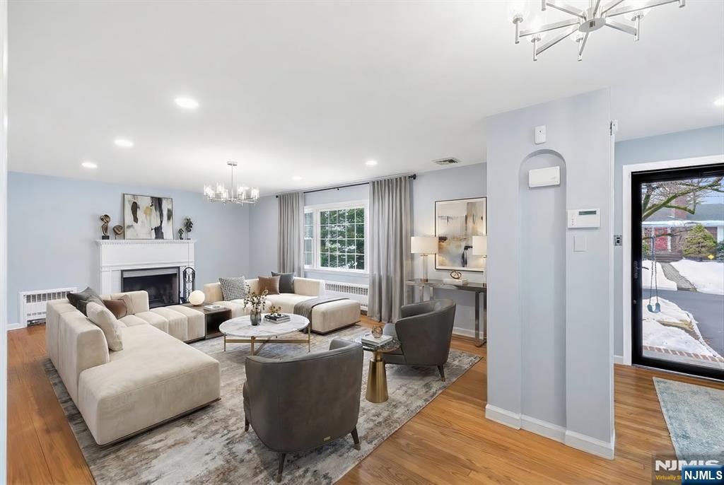 922 Wildwood Road Oradell, NJ 07649 - Photo 7 of 42 a living room with furniture a fireplace and a chandelier