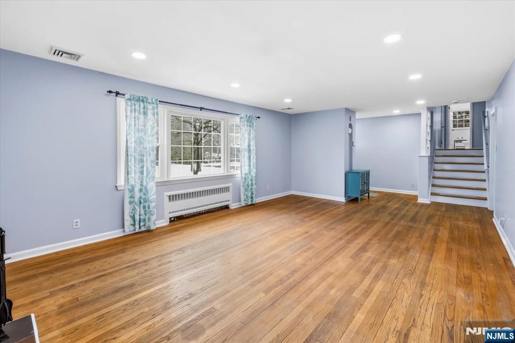 922 Wildwood Road Oradell, NJ 07649 - Photo 8 of 42 a view of empty room with wooden floor and fireplace