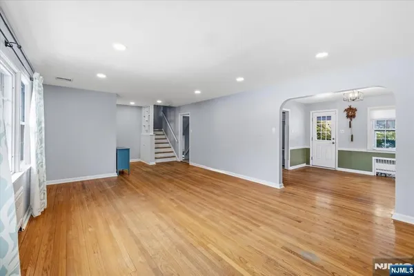 a view of a dining room with furniture a chandelier and wooden floor