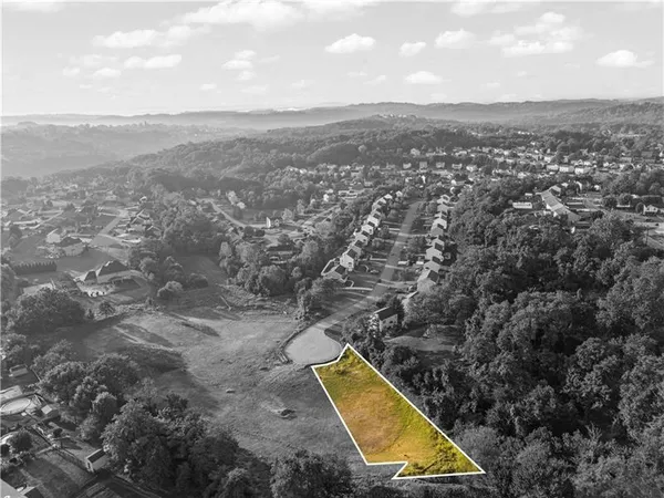 an aerial view of residential houses with outdoor space and swimming pool