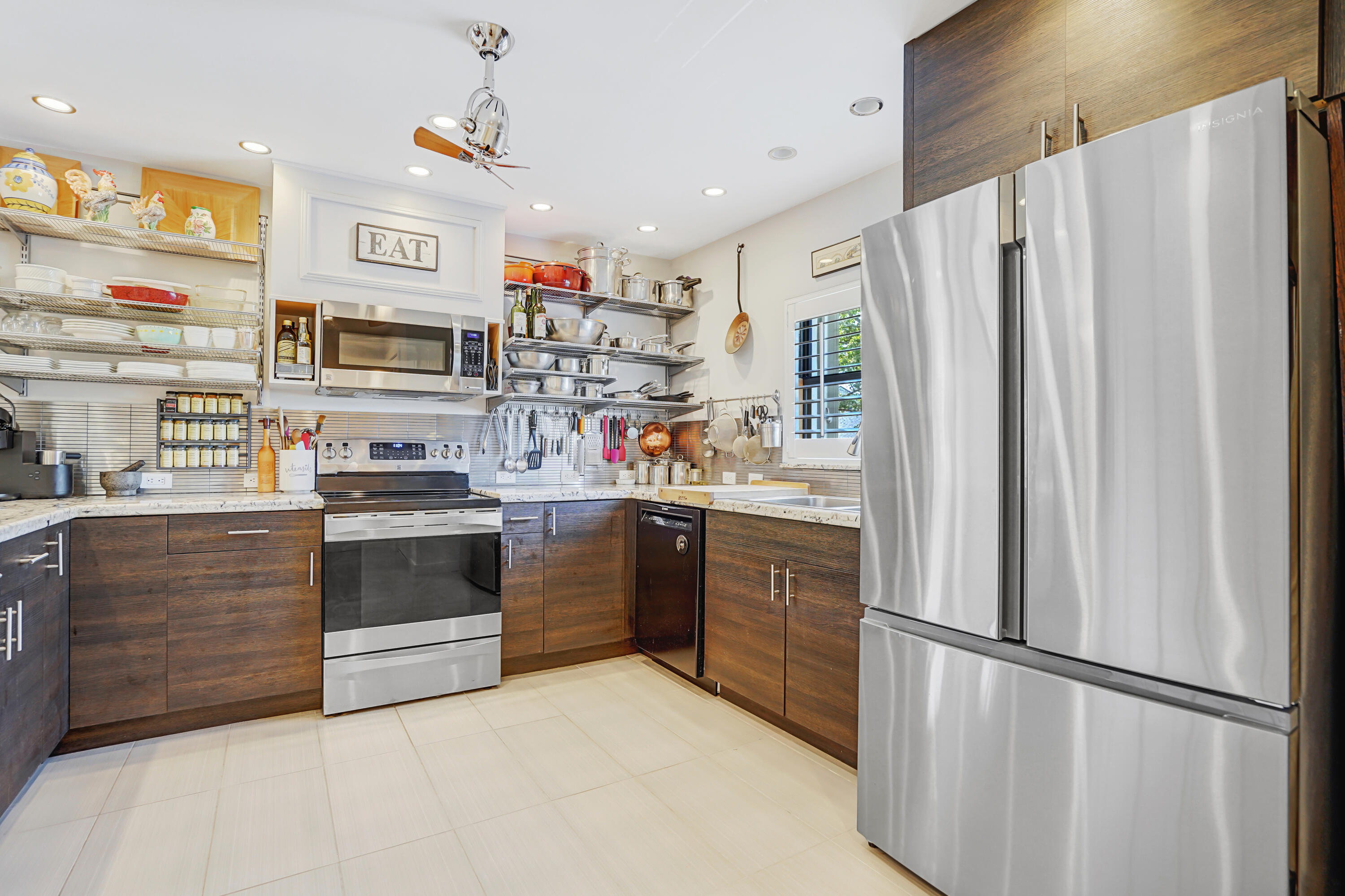 102 Clubhouse Circle Jupiter, FL 33477 - Photo 12 of 35 a kitchen with stainless steel appliances a refrigerator sink and microwave