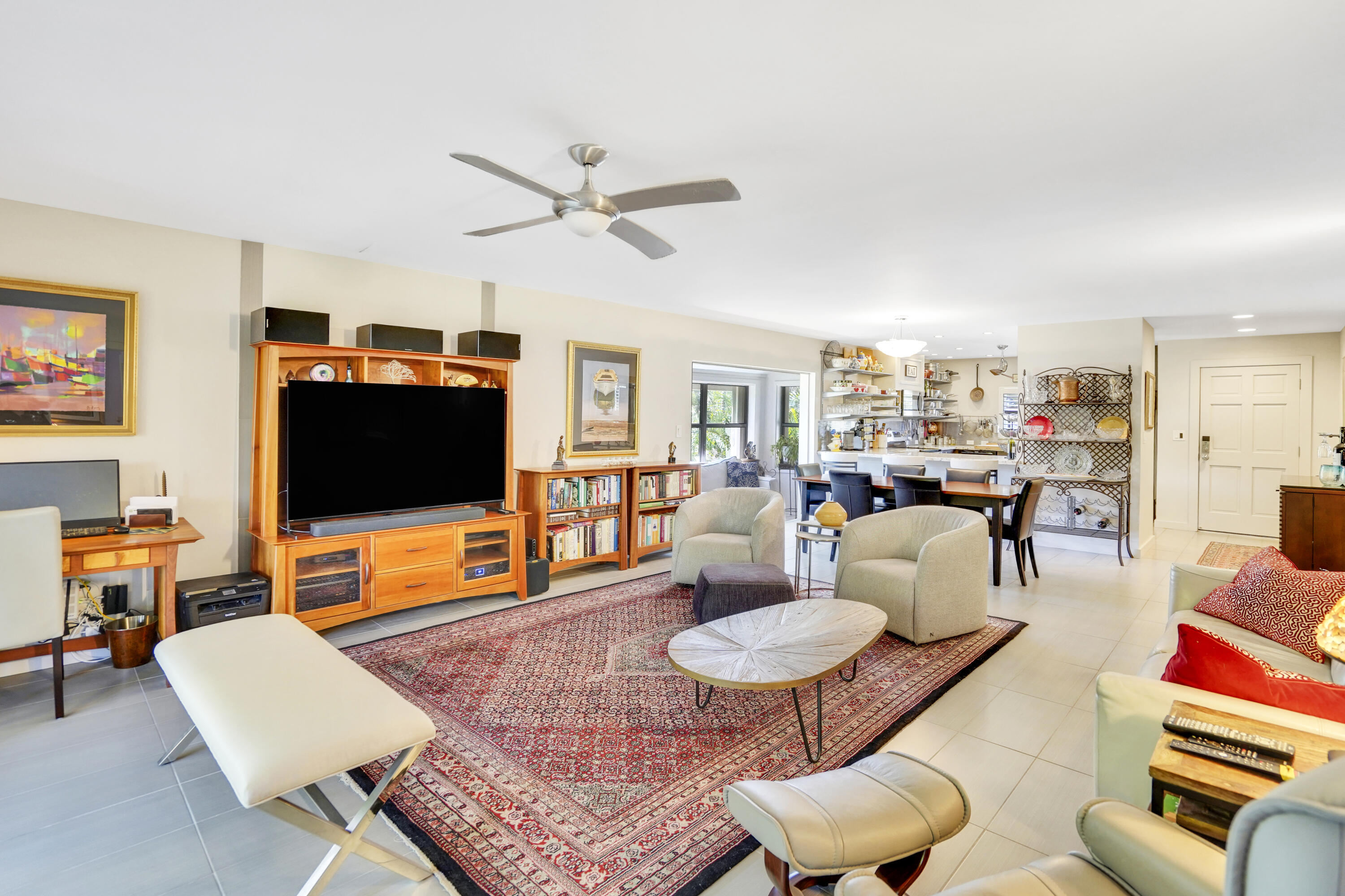 102 Clubhouse Circle Jupiter, FL 33477 - Photo 21 of 35 a living room with furniture and a flat screen tv