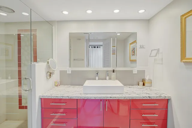 a bathroom with a granite countertop sink and a mirror