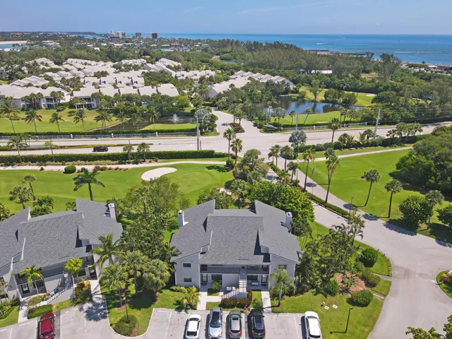 an aerial view of a houses with a lake view