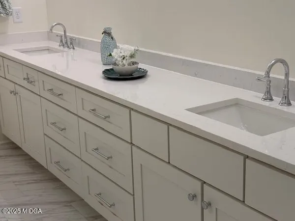a kitchen with sink and cabinets