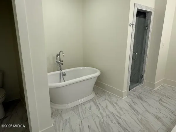 a white bath tub sitting in a bathroom