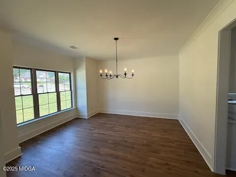 a view of a room with wooden floor and window