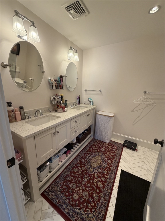17 Cardinal Street, Unit 17 Winchester, MA 01890 - Photo 18 of 42 a bathroom with a sink and a mirror