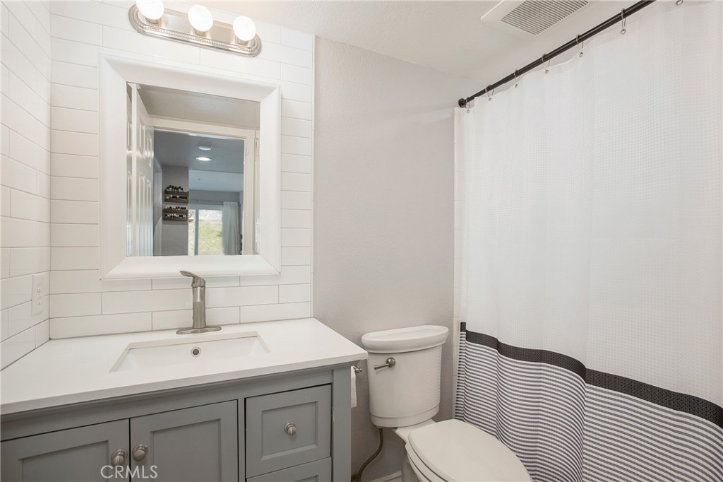 2865 Riachuelo San Clemente, CA 92673 - Photo 14 of 35 a bathroom with a toilet a sink and mirror