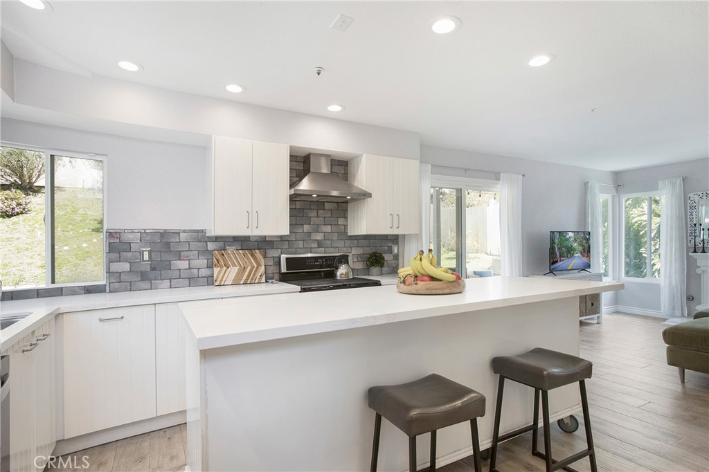 2865 Riachuelo San Clemente, CA 92673 - Photo 10 of 35 a kitchen with stainless steel appliances a sink a stove a refrigerator counter top space and a center island