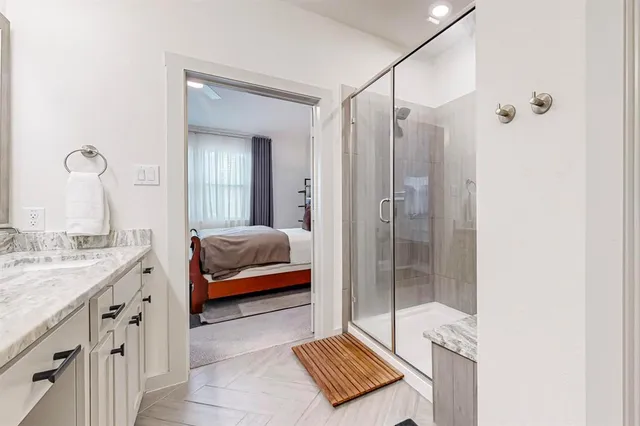 a bathroom with a granite countertop sink vanity and a mirror