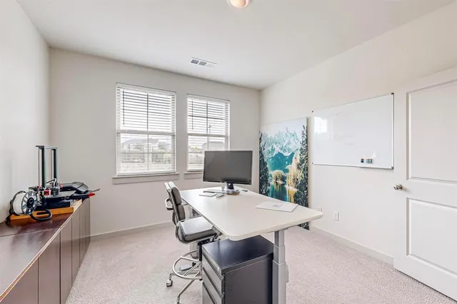 a view of a dining room with furniture and window