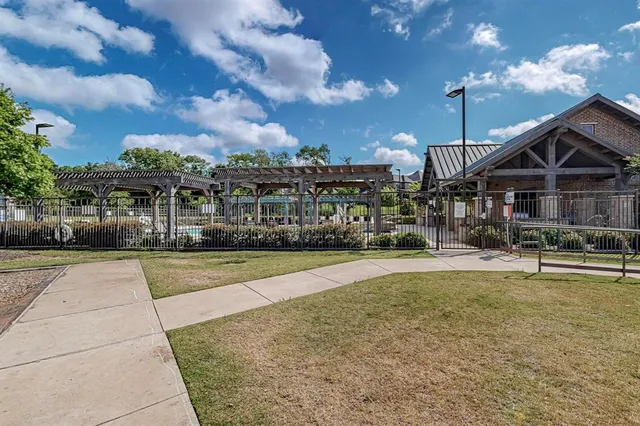 a view of a house with swimming pool and sitting area