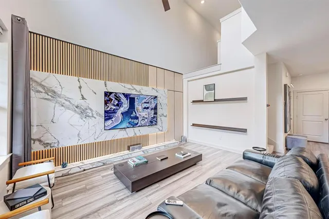 a living room with furniture and wall paintings