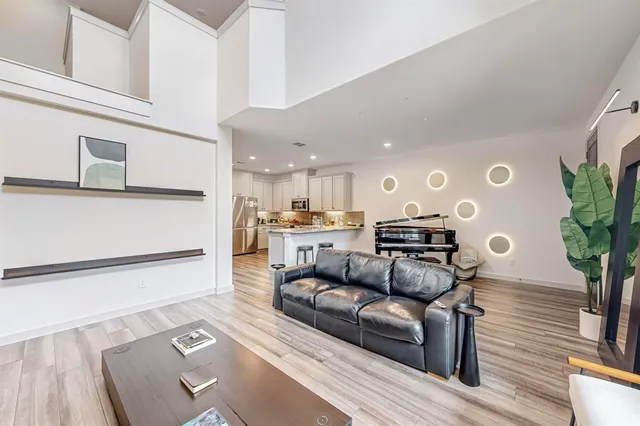 a living room with furniture and a potted plant