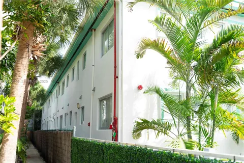 a view of a house with a tree in front of it