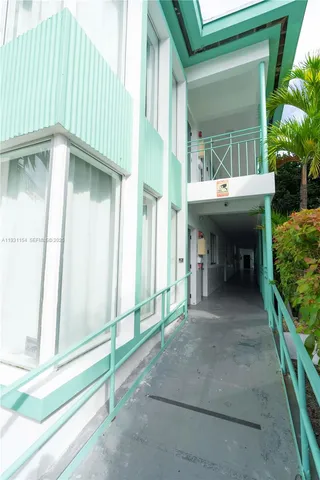 a view of a porch with furniture and a yard