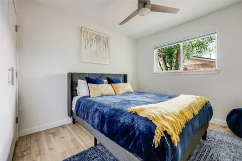 a bed sitting in a bedroom next to a window