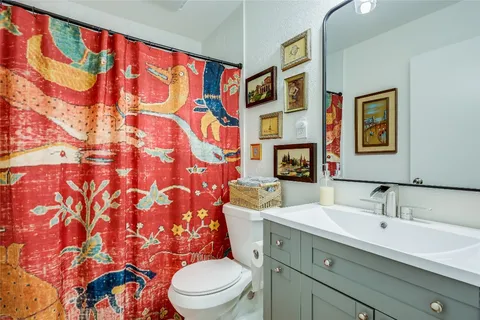 a bathroom with a toilet sink and mirror