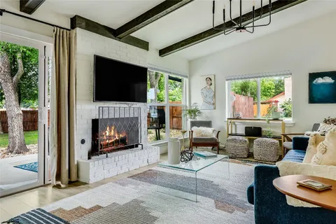 a living room with furniture fireplace and a flat screen tv