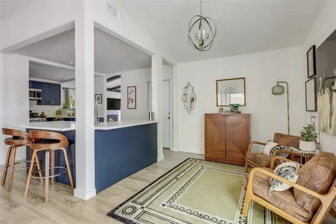 a view of a livingroom with furniture and a view of kitchen