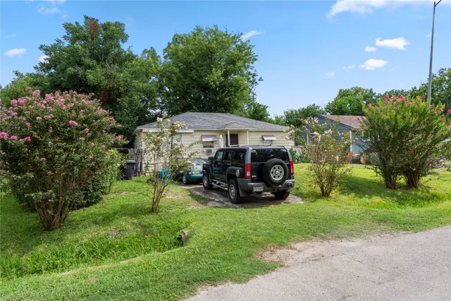 a view of a car is parked in front of a house