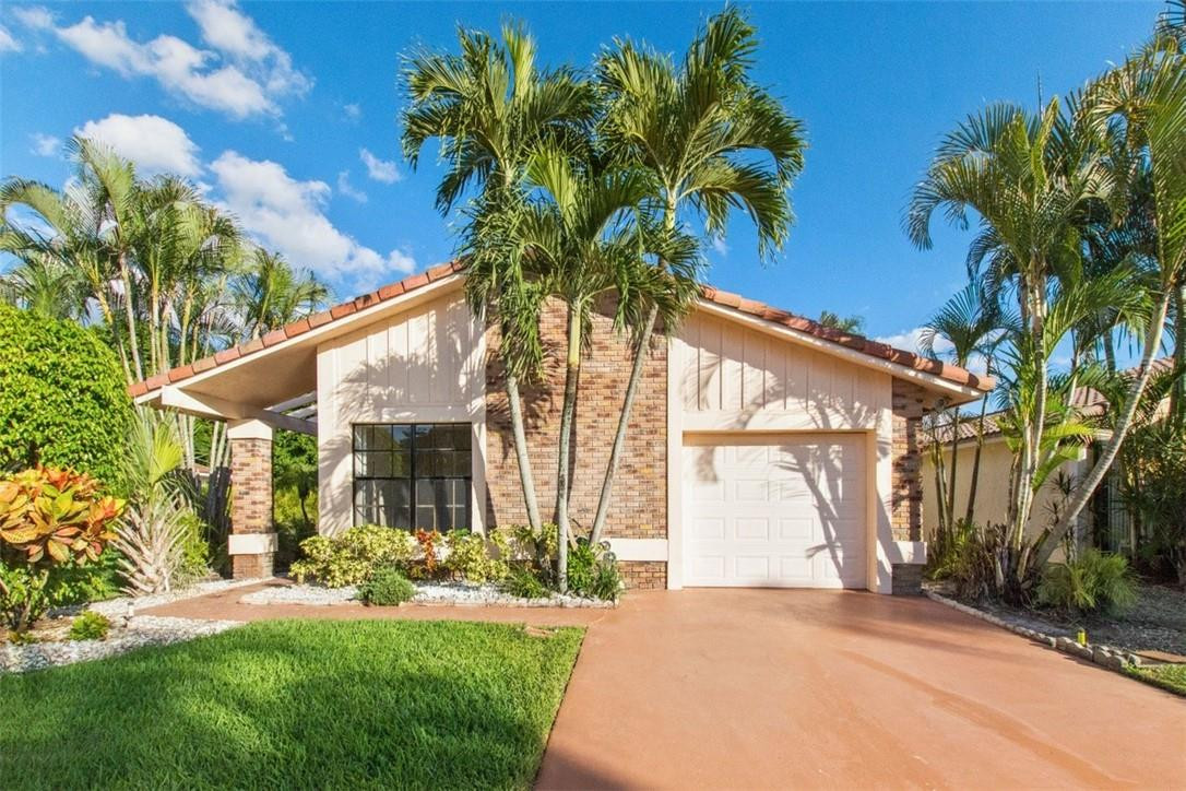 19554 Sea Pines Way Boca Raton, FL 33498 - Photo 1 of 26 a view of a house with a yard and potted plants