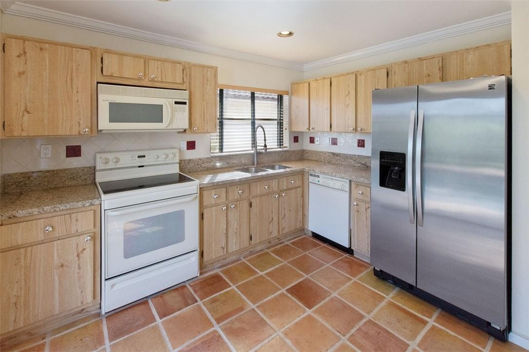 19554 Sea Pines Way Boca Raton, FL 33498 - Photo 13 of 26 a kitchen with a stove a sink and a refrigerator