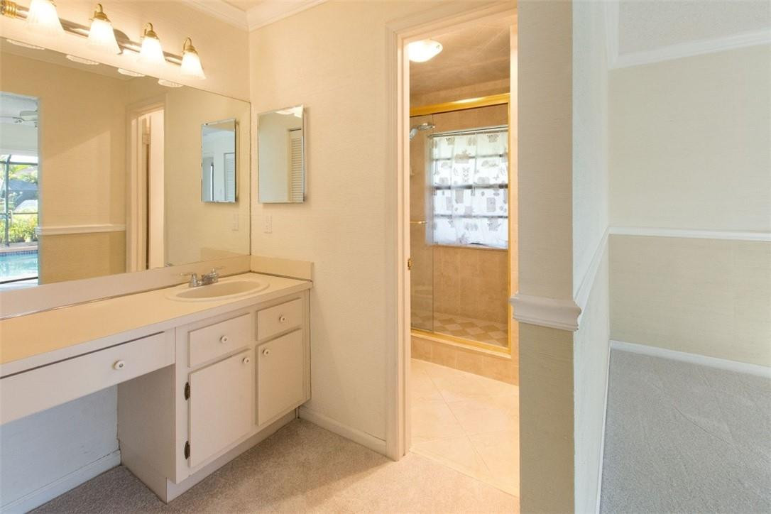 19554 Sea Pines Way Boca Raton, FL 33498 - Photo 17 of 26 a bathroom with a granite countertop sink and a mirror