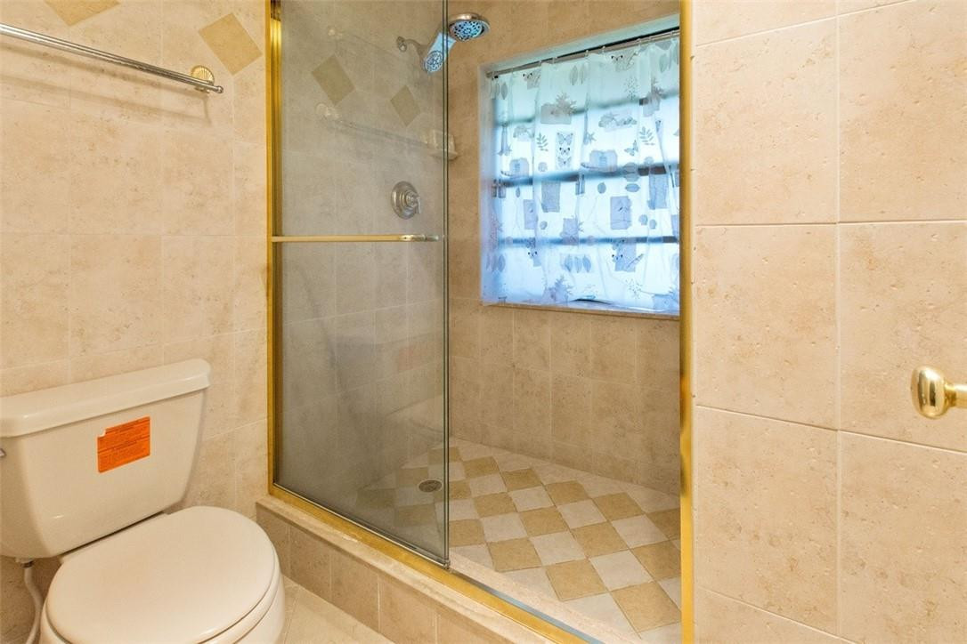 19554 Sea Pines Way Boca Raton, FL 33498 - Photo 22 of 26 a bathroom with a toilet and shower