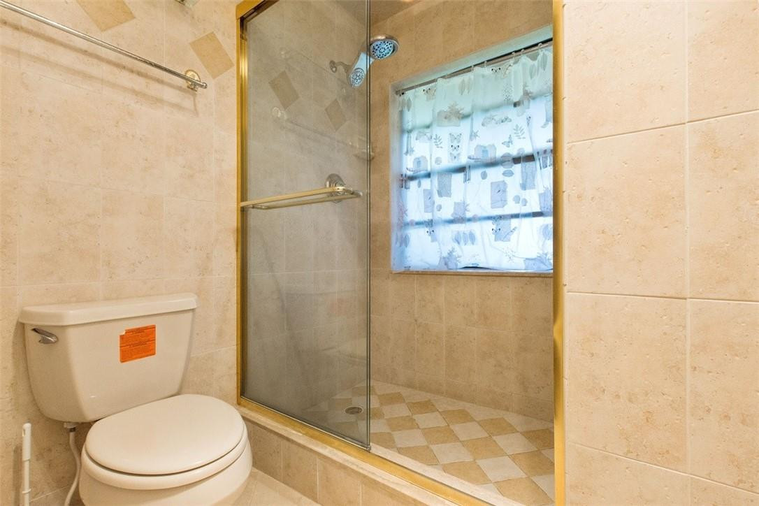 19554 Sea Pines Way Boca Raton, FL 33498 - Photo 23 of 26 a white toilet sitting next to a bathroom sink