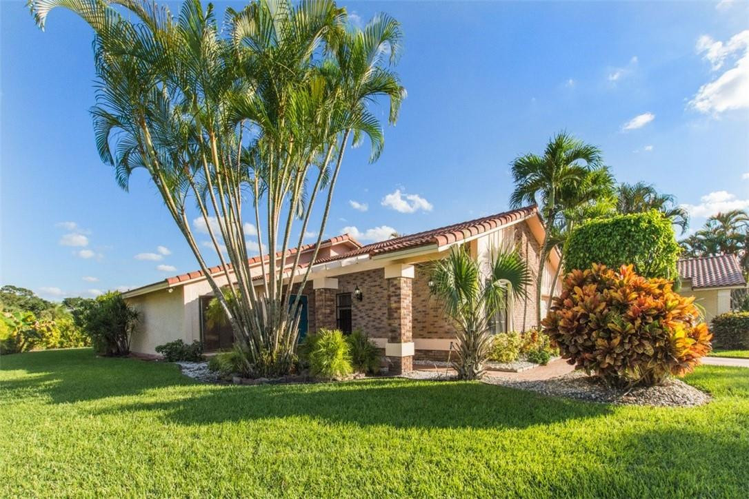19554 Sea Pines Way Boca Raton, FL 33498 - Photo 3 of 26 a view of a house with a tree in a yard