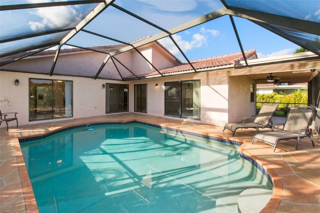 19554 Sea Pines Way Boca Raton, FL 33498 - Photo 5 of 26 a swimming pool with barbeque oven in front of it