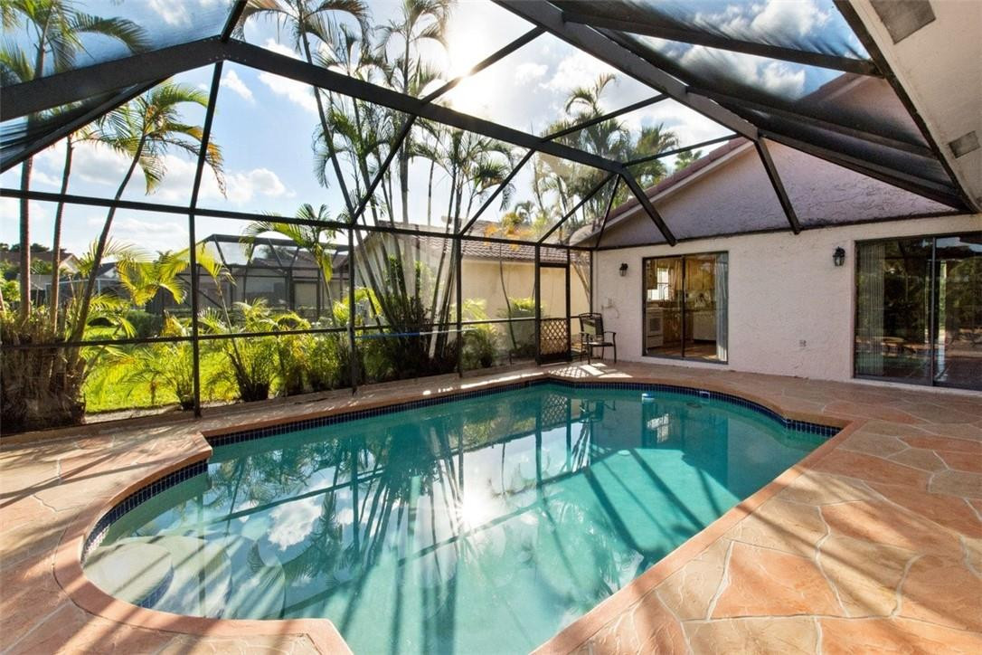 19554 Sea Pines Way Boca Raton, FL 33498 - Photo 7 of 26 a view of a swimming pool with a patio and a garden