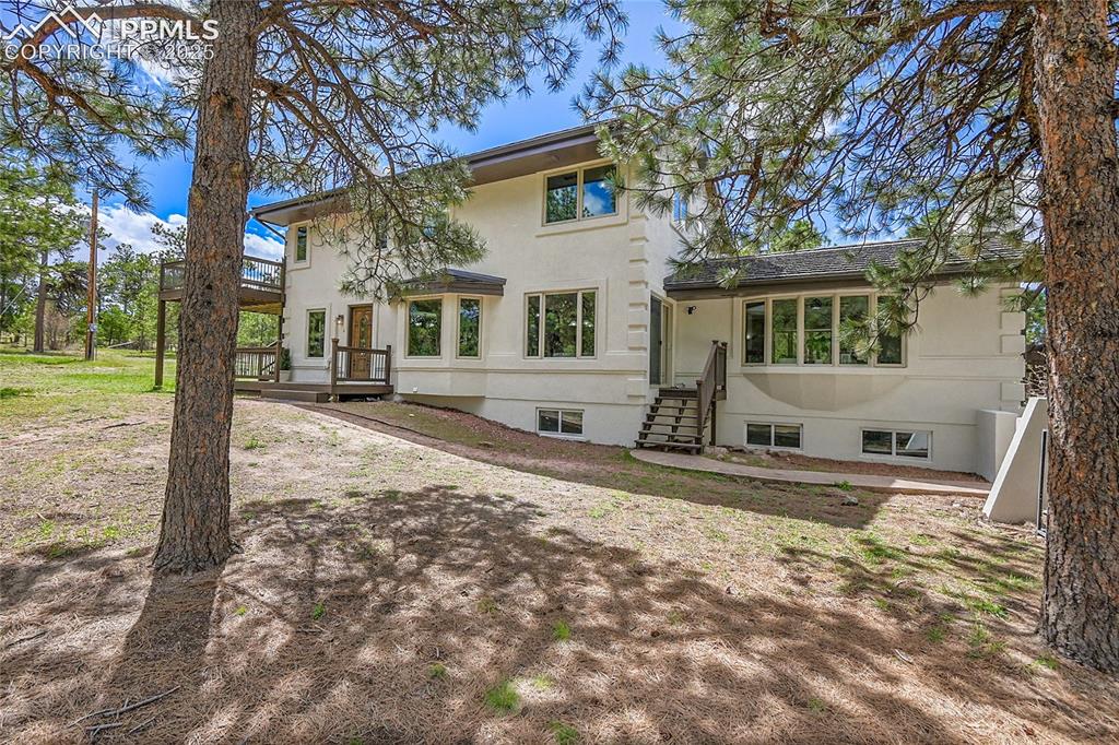17350 Goshawk Road Colorado Springs, CO 80908 - Photo 42 of 50 a front view of a house with a yard covered with trees