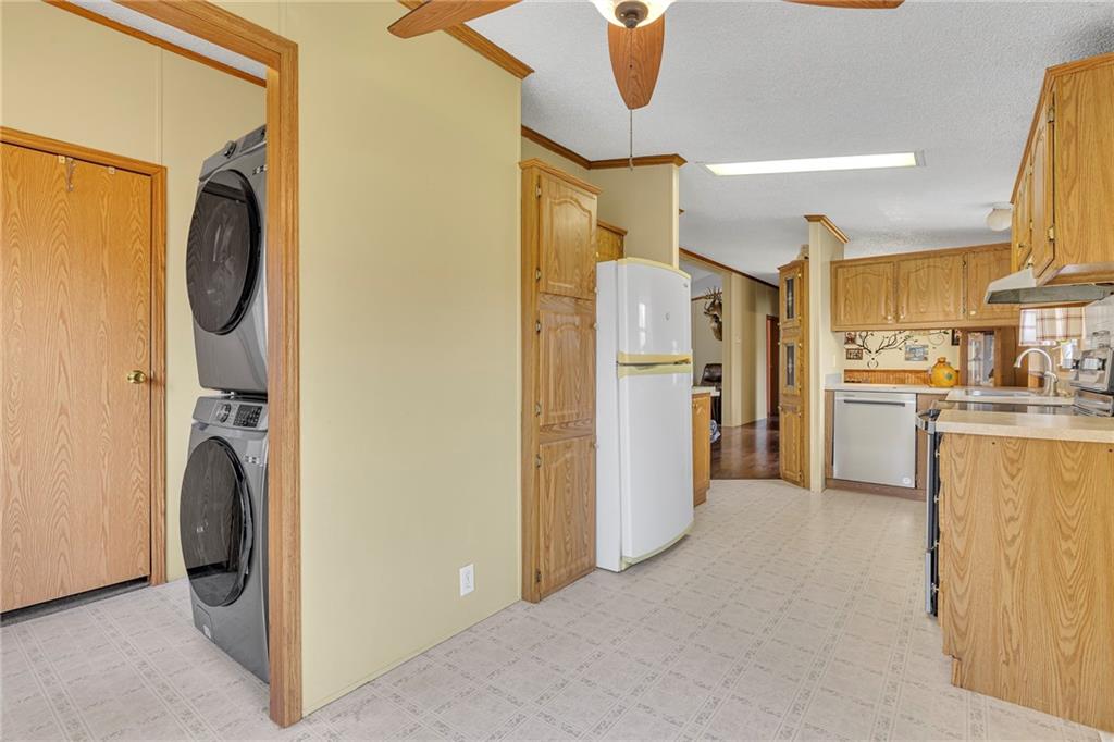 204 Hollowvue Road Wampum, PA 16157 - Photo 11 of 39 a view of a kitchen with refrigerator and sink