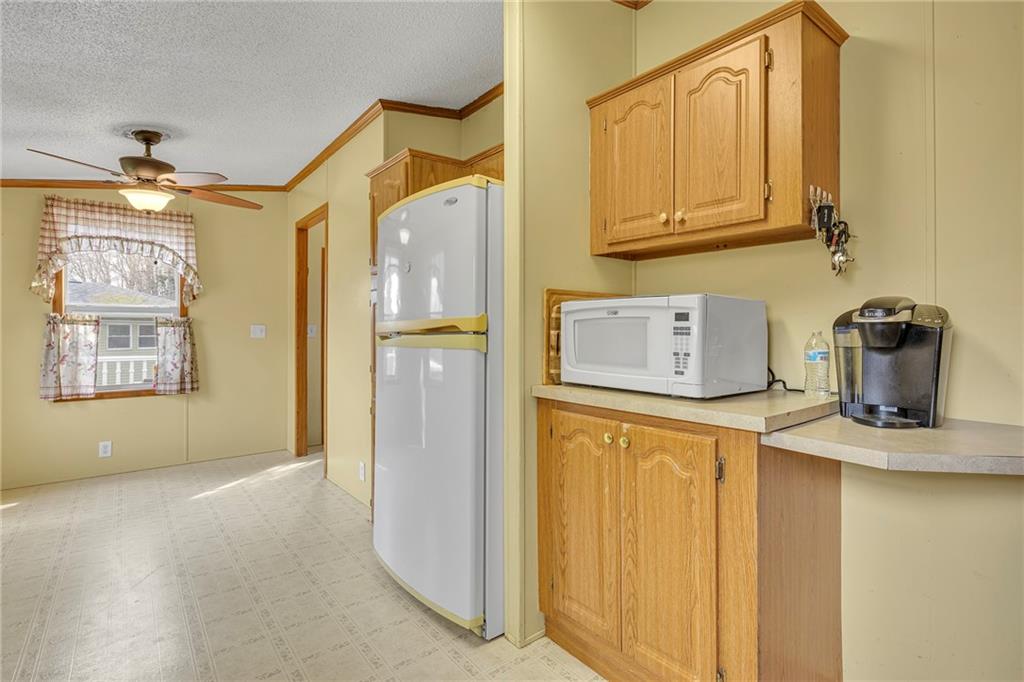 204 Hollowvue Road Wampum, PA 16157 - Photo 12 of 39 a hallway with a refrigerator and cabinets