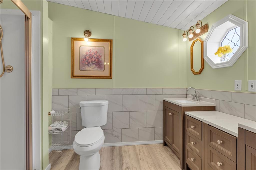 204 Hollowvue Road Wampum, PA 16157 - Photo 13 of 39 a bathroom with a toilet a sink and mirror
