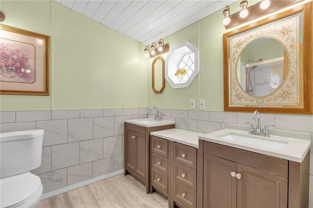 204 Hollowvue Road Wampum, PA 16157 - Photo 14 of 39 a bathroom with a toilet sink and mirror