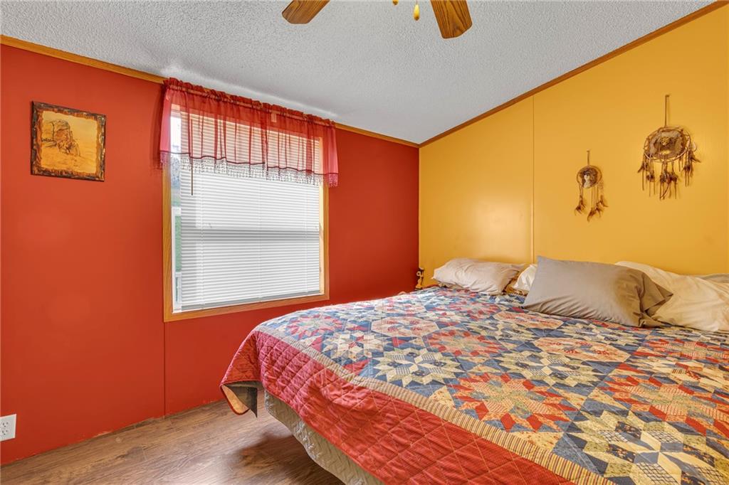 204 Hollowvue Road Wampum, PA 16157 - Photo 15 of 39 a bedroom with a bed and wooden floor