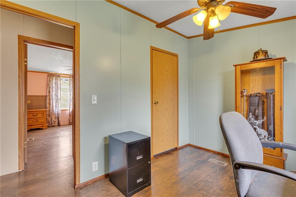 204 Hollowvue Road Wampum, PA 16157 - Photo 18 of 39 a view of a hallway with wooden floor and furniture