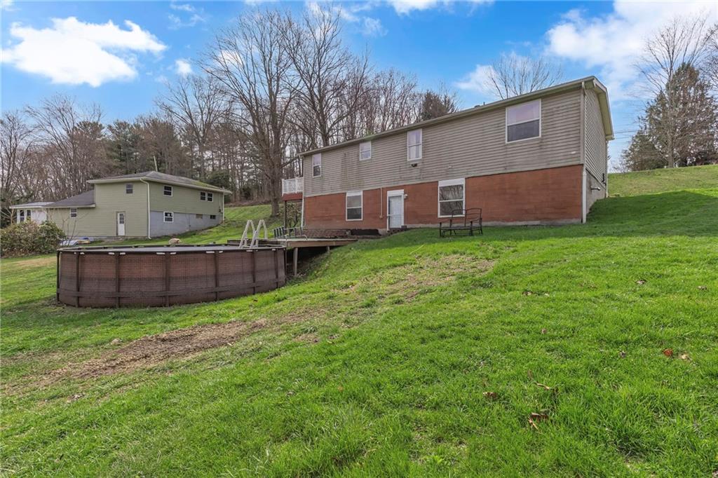 204 Hollowvue Road Wampum, PA 16157 - Photo 4 of 39 a view of a house with a yard and deck